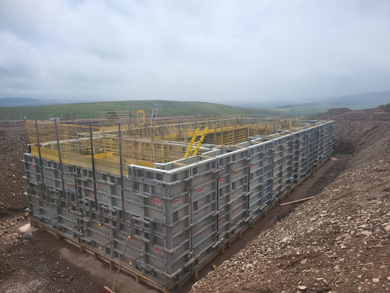 Concrete formwork and reinforcement in place for the substructure walls of the new control building at Hagshaw Hill Windfarm.